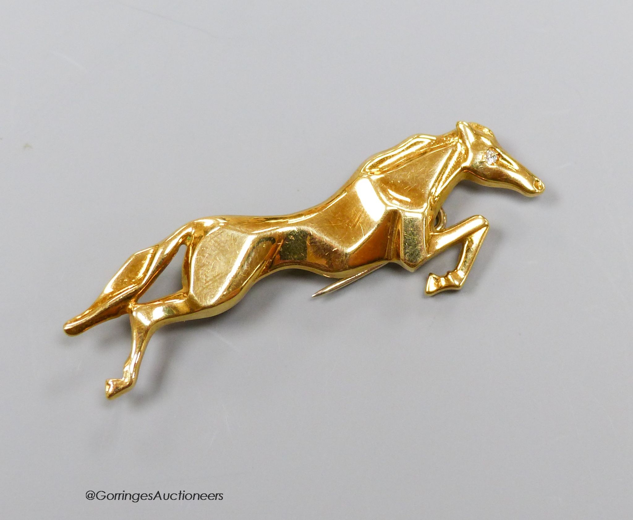 An 18k gold (750) diamond set horse brooch, gross 6.3g, 5cm.